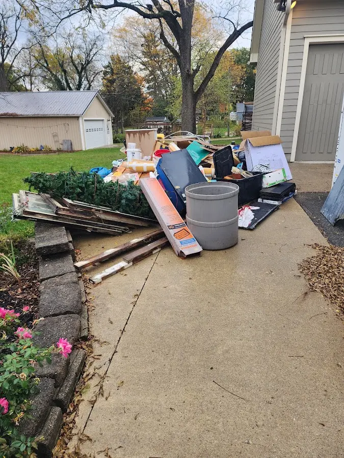 Dumpster being loaded with debris for 12 Yard Dumpster Rental in Emmett